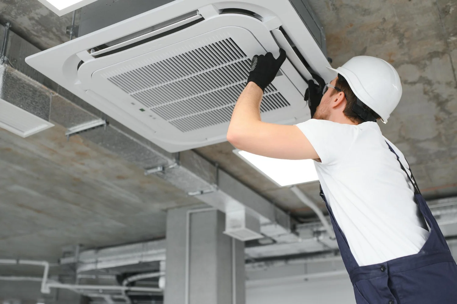 technician-cleans-air-conditioner-system
